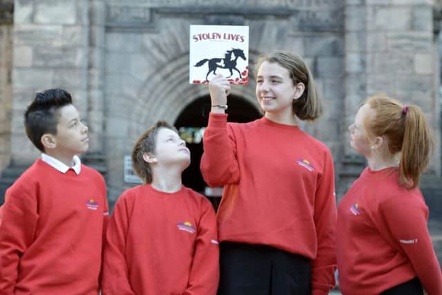 Logan Chan, William Wilson, Ashley Forrest and Kayleigh Louise Reid with the book. Picture: Julie Bull