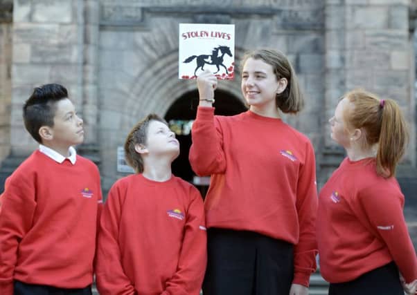 Logan Chan, William Wilson, Ashley Forrest and Kayleigh Louise Reid with the book. Picture: Julie Bull