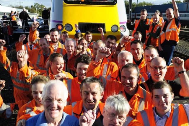 Peter Laycock, left, and Jimmy Borthwick celebrate with colleagues in front of the Craigentinny 100. Picture: Colin Hattersley