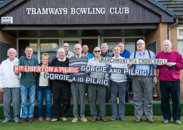 Members of the Pilrig club hold signs from the original tram system. Picture: Ian Georgeson
