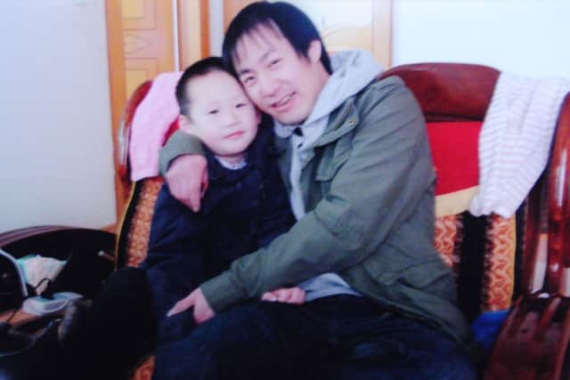 Jie Yu with one of his children. Picture: contributed