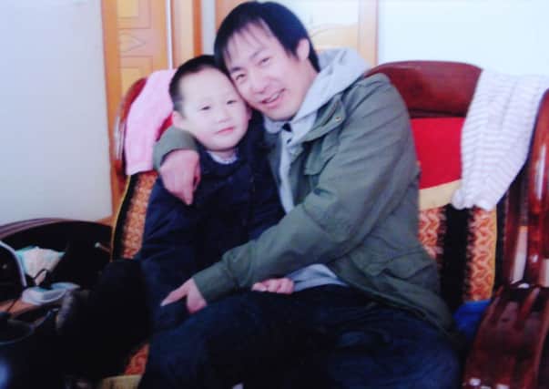 Jie Yu with one of his children. Picture: contributed