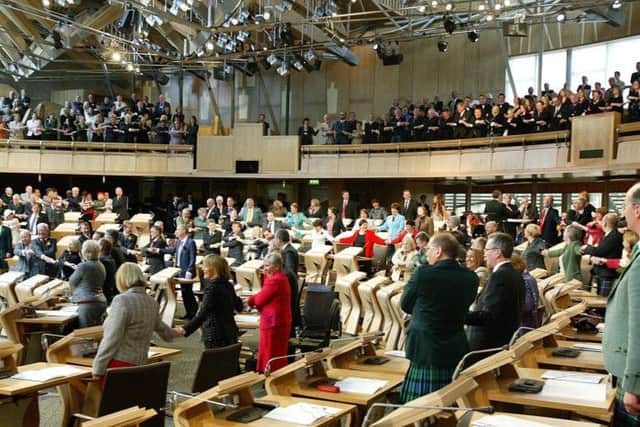 MSPs and guests sing along to Auld Lang Syne. Picture: Adam Elder