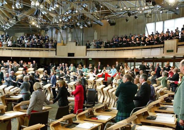 MSPs and guests sing along to Auld Lang Syne. Picture: Adam Elder