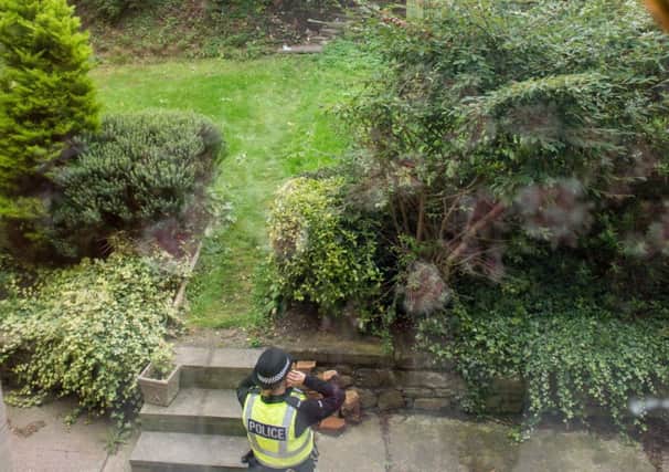 The garden is being guarded by police. Picture: Ian Georgeson