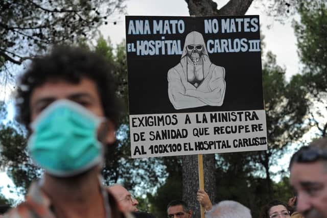 A health worker protests outside the hospital in Madrid where a nurse is being treated for the virus. Picture: Getty