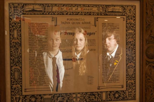 Abbi Taylor, Ruth Clark and Rachel Walker examine the roll of honour. Picture: Toby Williams.