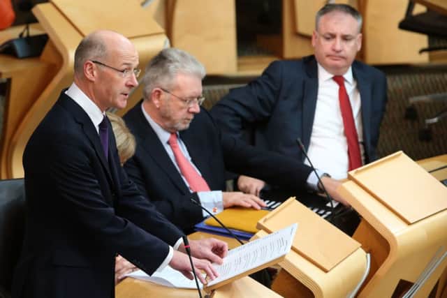 Scottish Finance Secretary John Swinney announces his draft budget for the year 2015-2016 at the Scottish Parliament. Pic: Andrew Milligan/PA Wire
