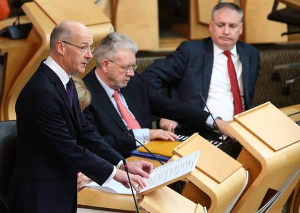 Scottish Finance Secretary John Swinney announces his draft budget for the year 2015-2016 at the Scottish Parliament. Pic: Andrew Milligan/PA Wire