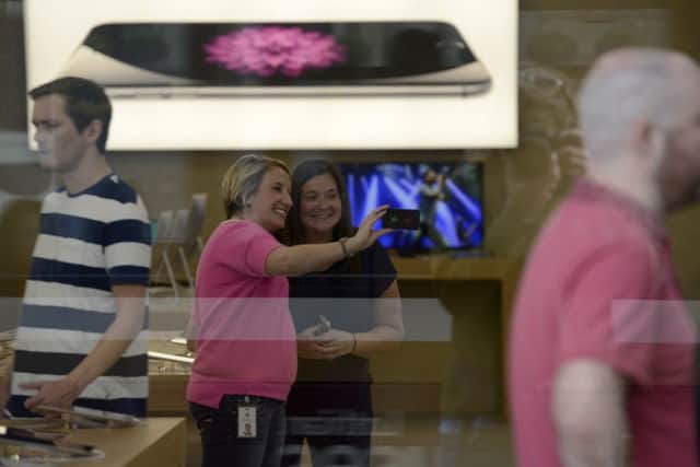 A selfie is taken inside the Apple store. Picture: Julie Bull