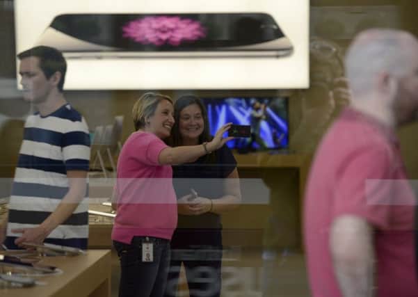 A selfie is taken inside the Apple store. Picture: Julie Bull