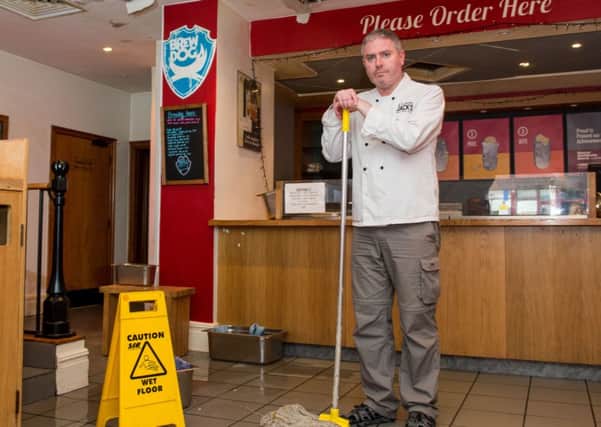 Jack Muir was forced to mop up after the restaurant was flooded