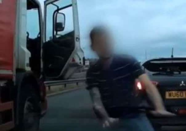 The lorry driver exits to confront the motorist.