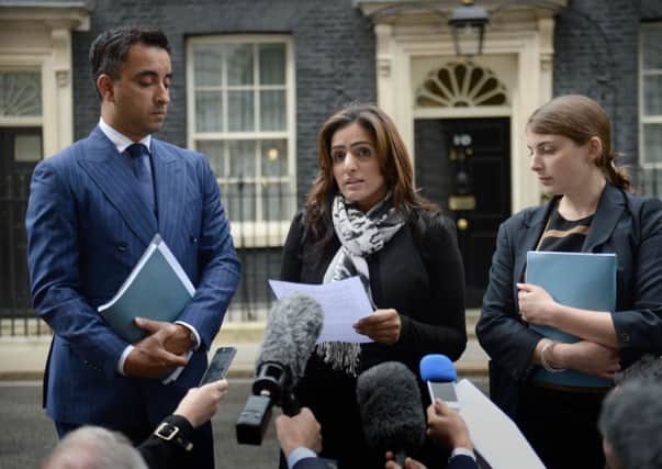 Jasmine Rana (centre) Aamer Anwar (left) and Catherine Higham (right) talk to the media outside Downing Street. Pic: PA