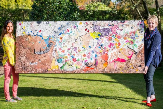 Artist Wendy Helliwell, left, and skin-care consultant Marjory Kenny display the unique piece of art. Picture: Ian Georgeson