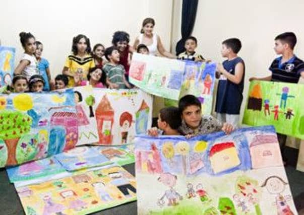The children with some of their artwork. Picture: comp