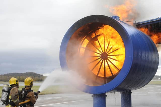 Members of the Airport Fire Service put in some practice with the training rig. Picture: Greg Macvean