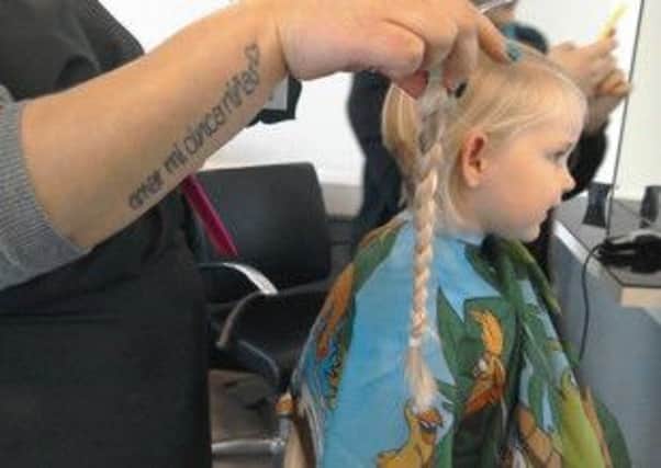 The scissors get to work on Charlotte's hair. Picture: comp