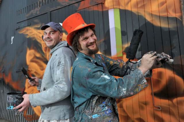 Painter Steve Anderson and artist Chris Rutterford prepare the archways on Market Street for the graffiti art. Picture: Jane Barlow