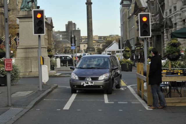 A motorist drives down the cycle path on George Street. Picture: Scott Taylor
