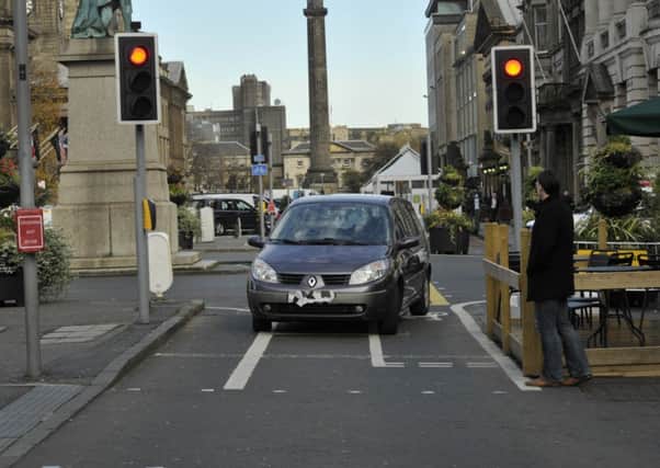 A motorist drives down the cycle path on George Street. Picture: Scott Taylor