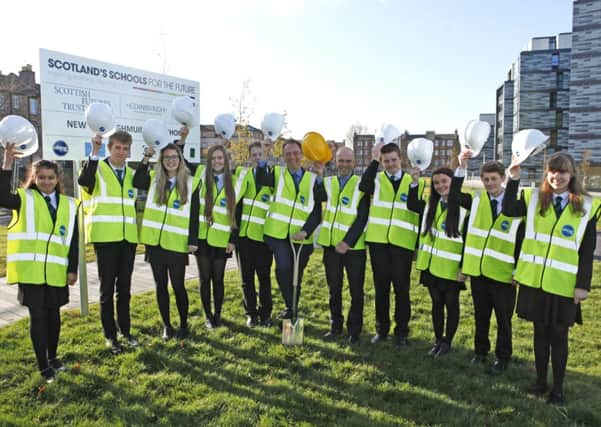 Alasdair Allan MSP cuts the first turf at the new Boroughmuir High site with pupils and headteacher David Dempster. Picture: Toby Williams