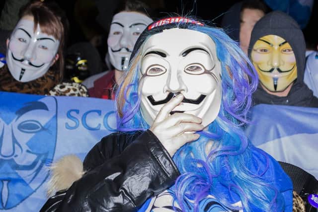 Members of 'Anonymous Scotland' marched from Castlehill down to Holyrood. Picture: Mhairi Bell-Moodie