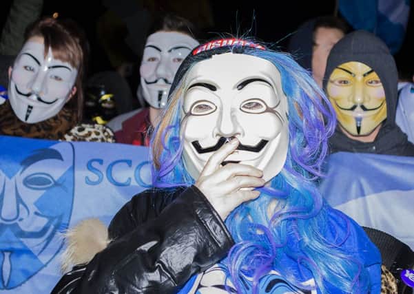Members of 'Anonymous Scotland' marched from Castlehill down to Holyrood. Picture: Mhairi Bell-Moodie