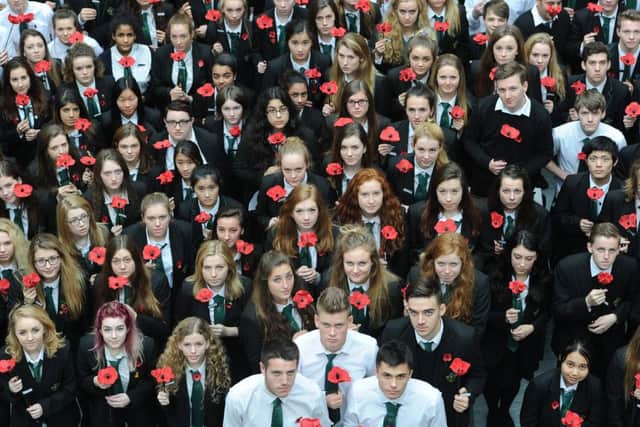 Boroughmuir pupils carry clay poppies they made for each of the former pupils and staff who died in the Great War. Picture: Neil Hanna
