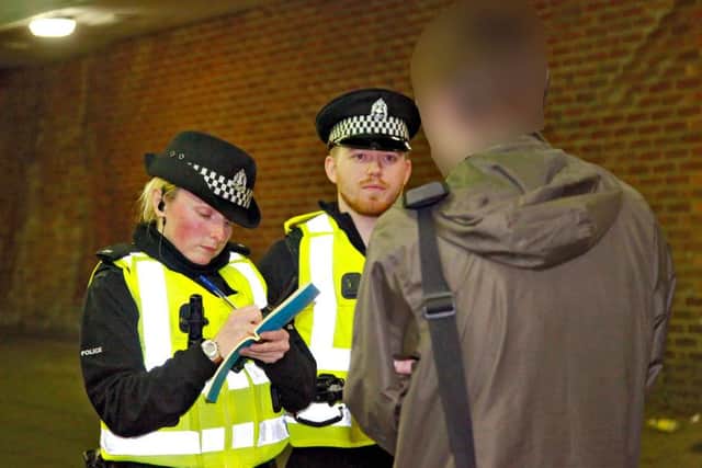 Police officers question a member of the public in the Pilton area. Picture: Scott Louden
