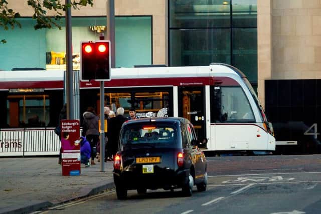 A taxi is halted at the junction of Waverley Bridge and Princes Street. Picture: Scott Louden