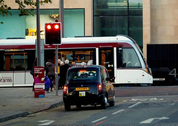 A taxi is halted at the junction of Waverley Bridge and Princes Street. Picture: Scott Louden