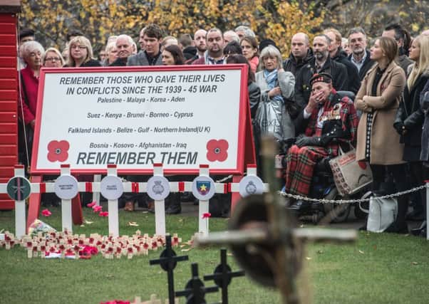 War veteran and fundraiser Tom Gilzean (in wheelchair) at the city's Garden of Remembrance service. Picture: Phil Wilkinson