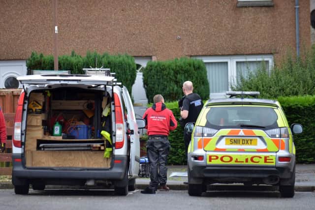 Forensics experts combed the house yesterday.Picture: Jon Savage