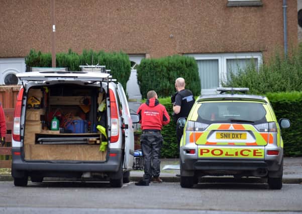 Forensics experts combed the house yesterday.Picture: Jon Savage