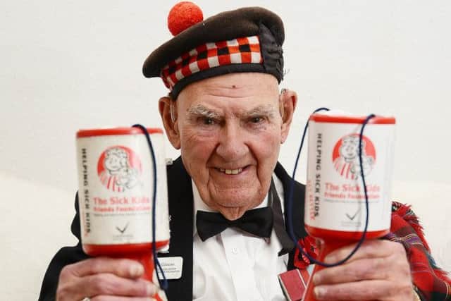 Tom Gilzean with his collecting tins. Picture: Neil Hanna