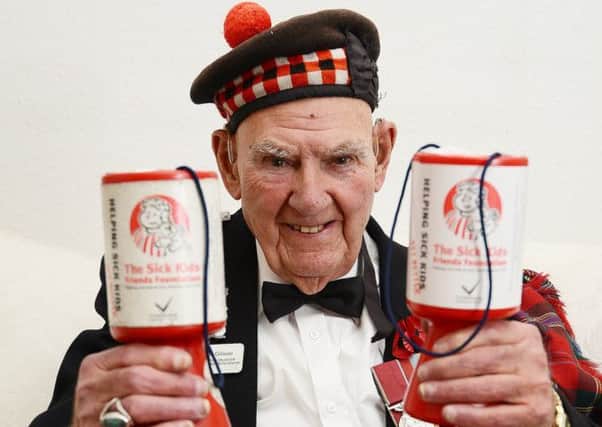 Tom Gilzean with his collecting tins. Picture: Neil Hanna