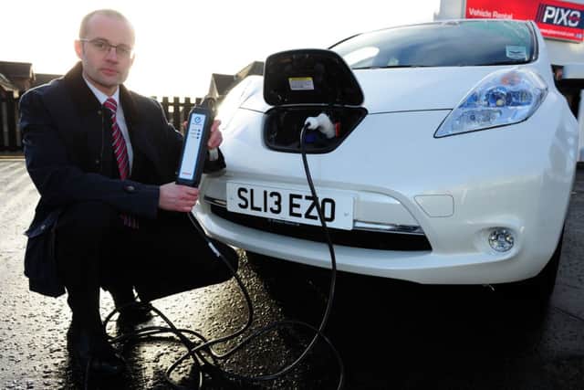 David Stead charges up a Nissan Leaf. Picture: Ian Rutherford
