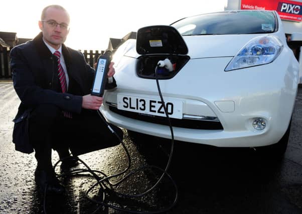 David Stead charges up a Nissan Leaf. Picture: Ian Rutherford