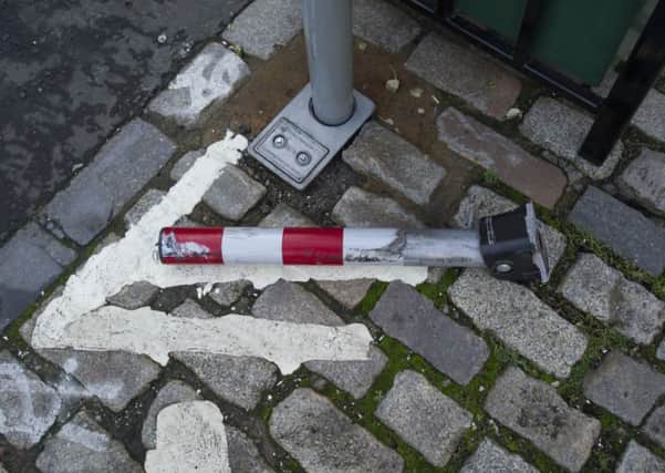 Seven out of eight bollards have been damaged by cars  flouting the rules on George Street bike lane. Picture: Scott Taylor
