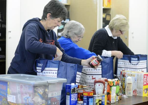 Food bank volunteers begin the work of sorting through provisions. Picture: Neil Hanna