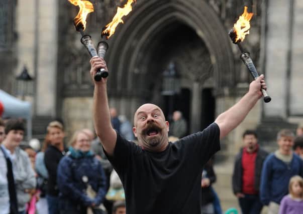 A performer draws a crowd at the Fringe. Picture: Ian Rutherford