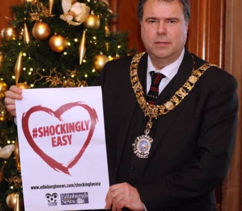 Pic Lisa Ferguson 08/12/2014
Rt Hon Donald Wislon - Lord Lieutenant and Lord Provost of City of Edinburgh holds the poster for Evening News Shockingly Easy Campaign