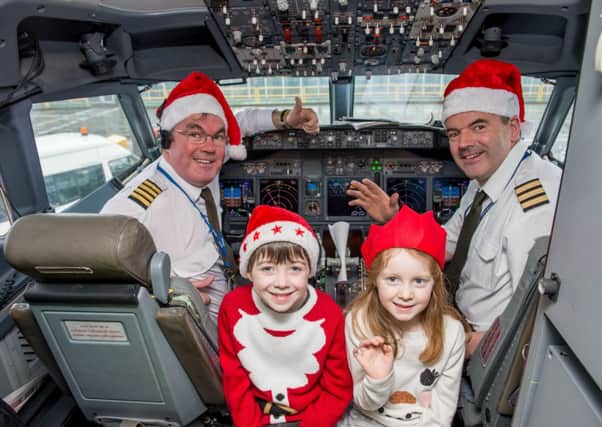 Beth Watson, six, and Fraser Watson, seven, in the cockpit with Captain Ian Barclay and Gerry Lynch. Picture: Ian Georgeson