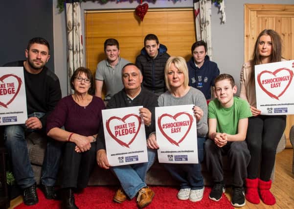Jamie Skinner's family with the appeal poster. Pic: Ian Georgeson
