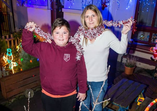 Libby Caldwell with son Calum Tait at their Muirhouse Park home. Pictured: Ian Georgeson