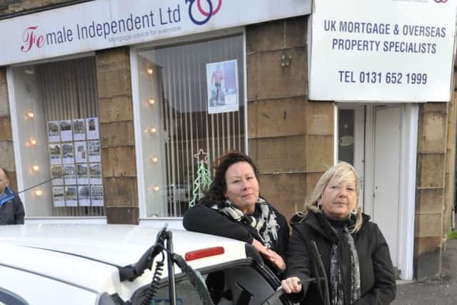 Susan Young, left, and Carol Begbie examine the damage to the car. Picture: Phil Wilkinson