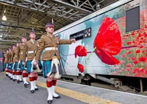 Royal Regiment of Scotland march along the side of East Coast loco 91111 For the Fallen'