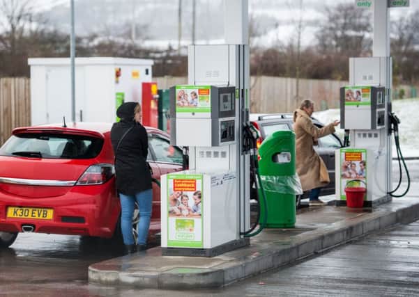 Drivers fill up at the Asda Straiton fuel pumps. Pic: Ian Georgeson