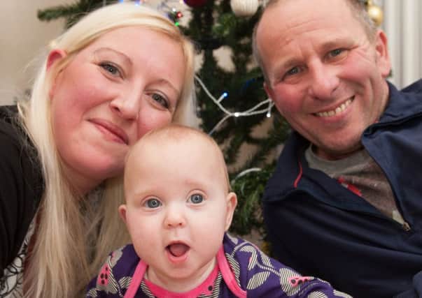 Emily Cressey enjoys her first Christmas at home with mum Claire and dad Alan. Picture: Phil Wilkinson